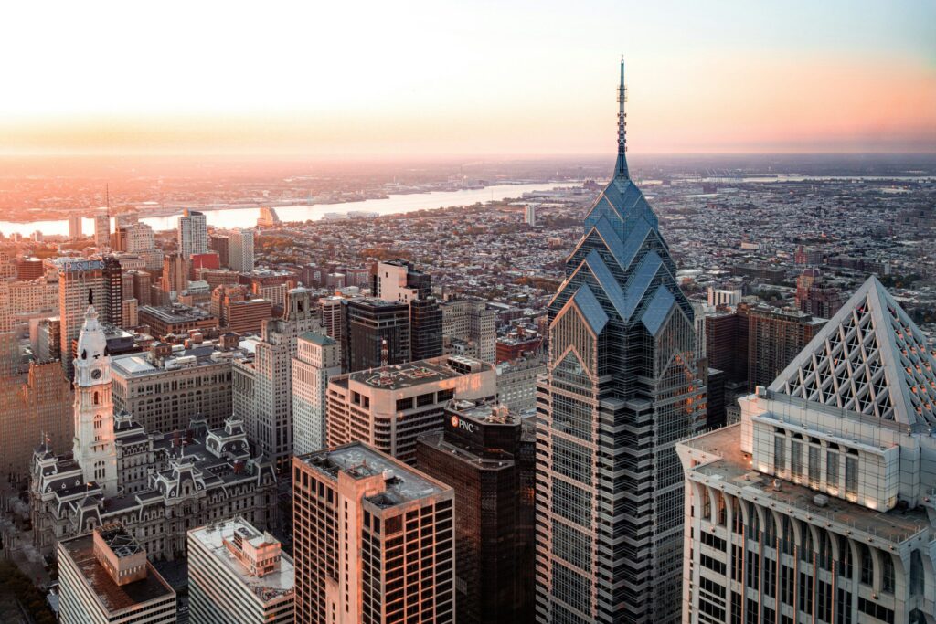 Philadelphia skyline in morning with view of river and sunrise.