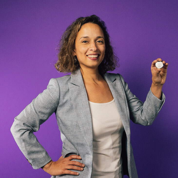 Yasmine Mustafa, ROAR's President and Co-founder, holding up a ROAR wearable panic button.